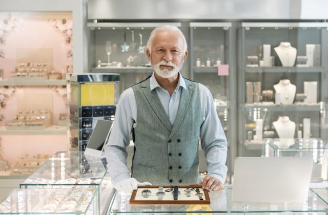 Senior man in jewelry store selling luxury watches